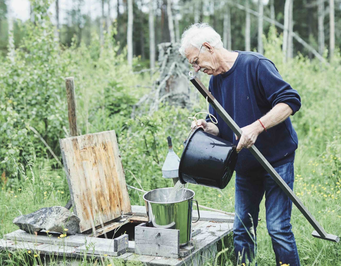 Anders is getting water from a well