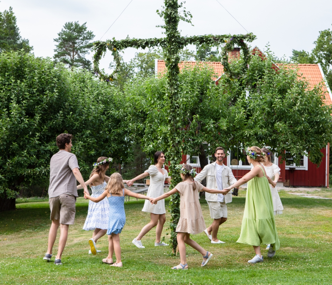 People dancing around a may pole