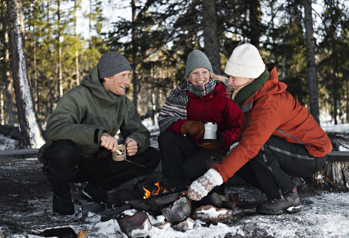 People enjoying picnic by fire