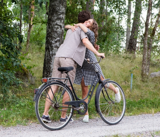 Man and woman hugging, bikeride