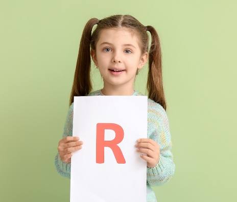 Girl holding the letter R